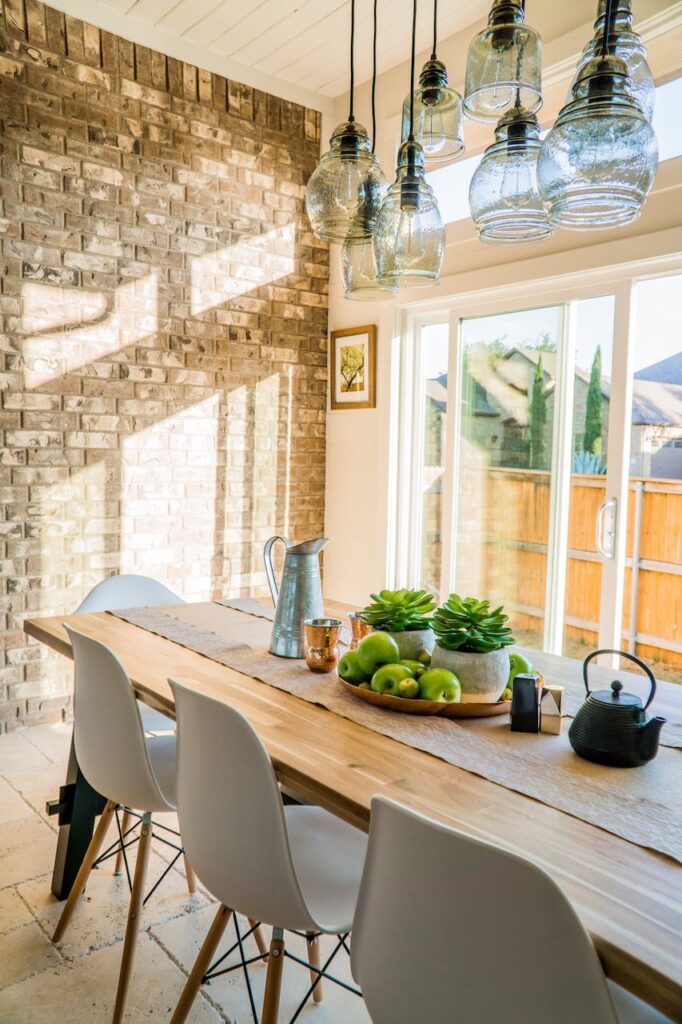 Home with Long butcher block dining table with gray chairs.